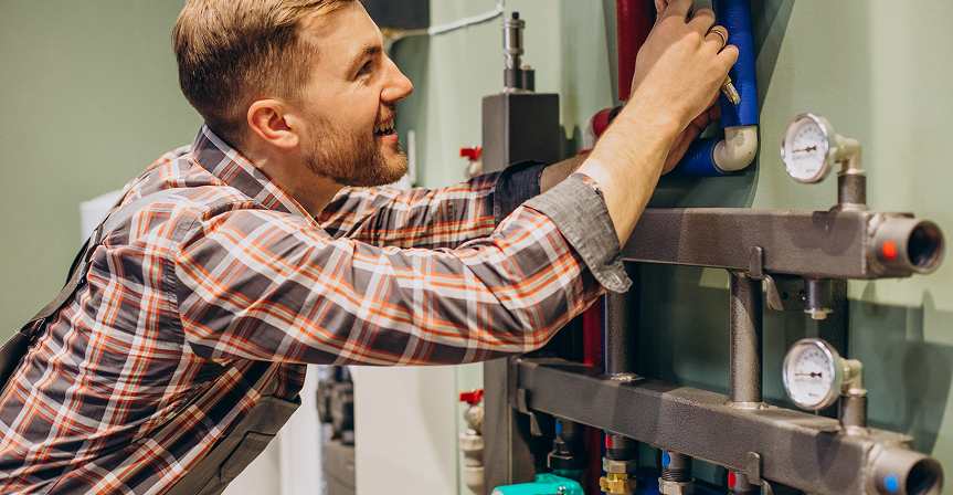 Technician working on a residential heating manifold